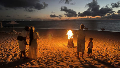 Guests attending a bonfire dinner at Sailrock's restaurant The Cove on South Caicos island. S'mores optional.