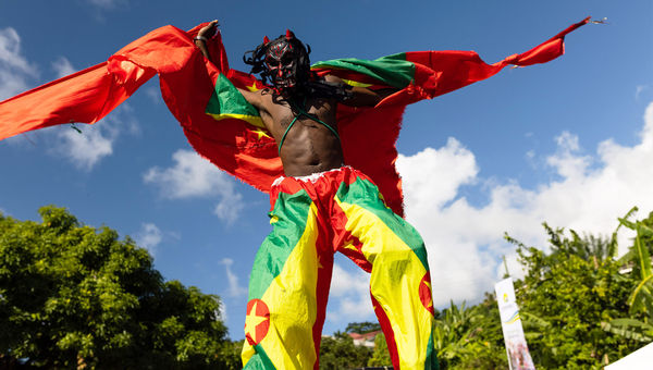 A stilt walker takes part in Grenada’s 2022 Spicemas festival.