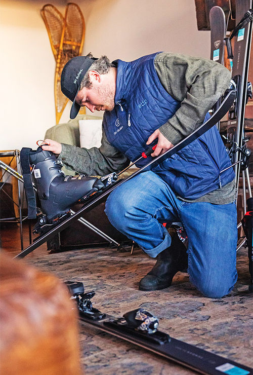 A technician with Ski Butlers works on skis.