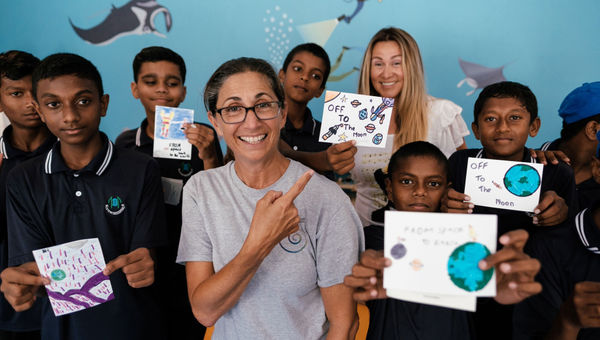 Astronaut Nicole Stott conducting art classes with the children participating in space camp.