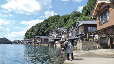 A woman retrieves a fishing basket in the village of Ine in Kyoto.