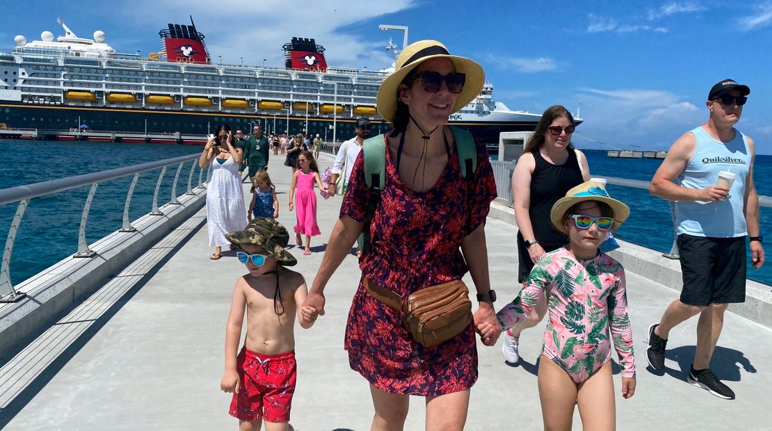 Disney Magic guests begin their walk down the pier toward Lookout Cay at Lighthouse Point, Disney Cruise Line's new private destination.