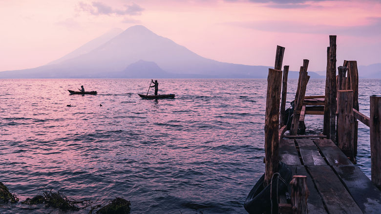 Sunset over the hills of Lake Atitlan in Guatemala, a destination considered a dupe of Italy’s Lake Como by Intrepid Travel, which offers guided tours in the region.