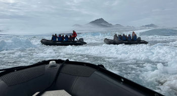 Guests head out on a Zodiac excursion off the coast of Greenland.