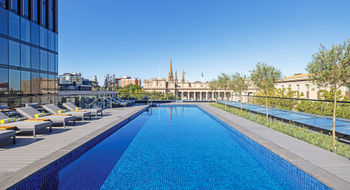 Le Meridien Melbourne's heated pool and deck is popular throughout the day. At night, the lights from the surrounding skyscrapers add to the magic