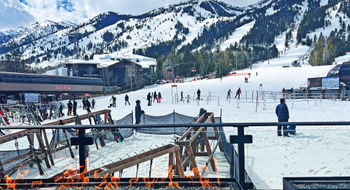 The patio at the Four Seasons Resort Jackson Hole's Handle Bar provides a front-row seat to the resort's base lifts and stunning mountains.