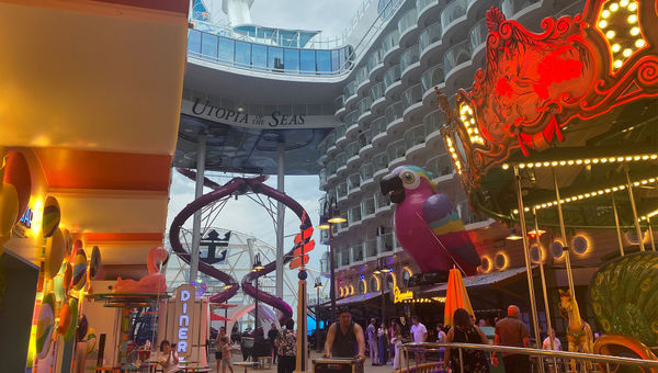 The Utopia of the Seas’ Boardwalk neighborhood with a carousel, giant parrot and the Ultimate Abyss slides.