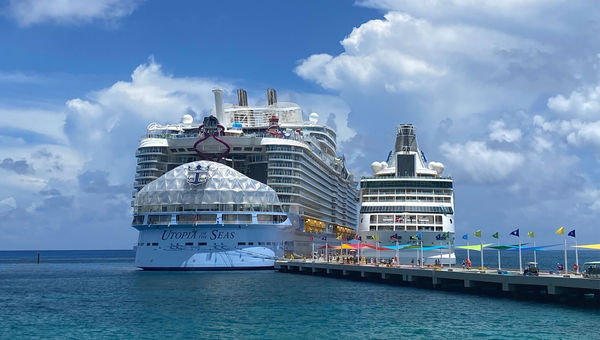 The Utopia of the Seas, the second-largest cruise ship on Earth, docked next to the Vision of the Seas at Perfect Day at Coco Cay.